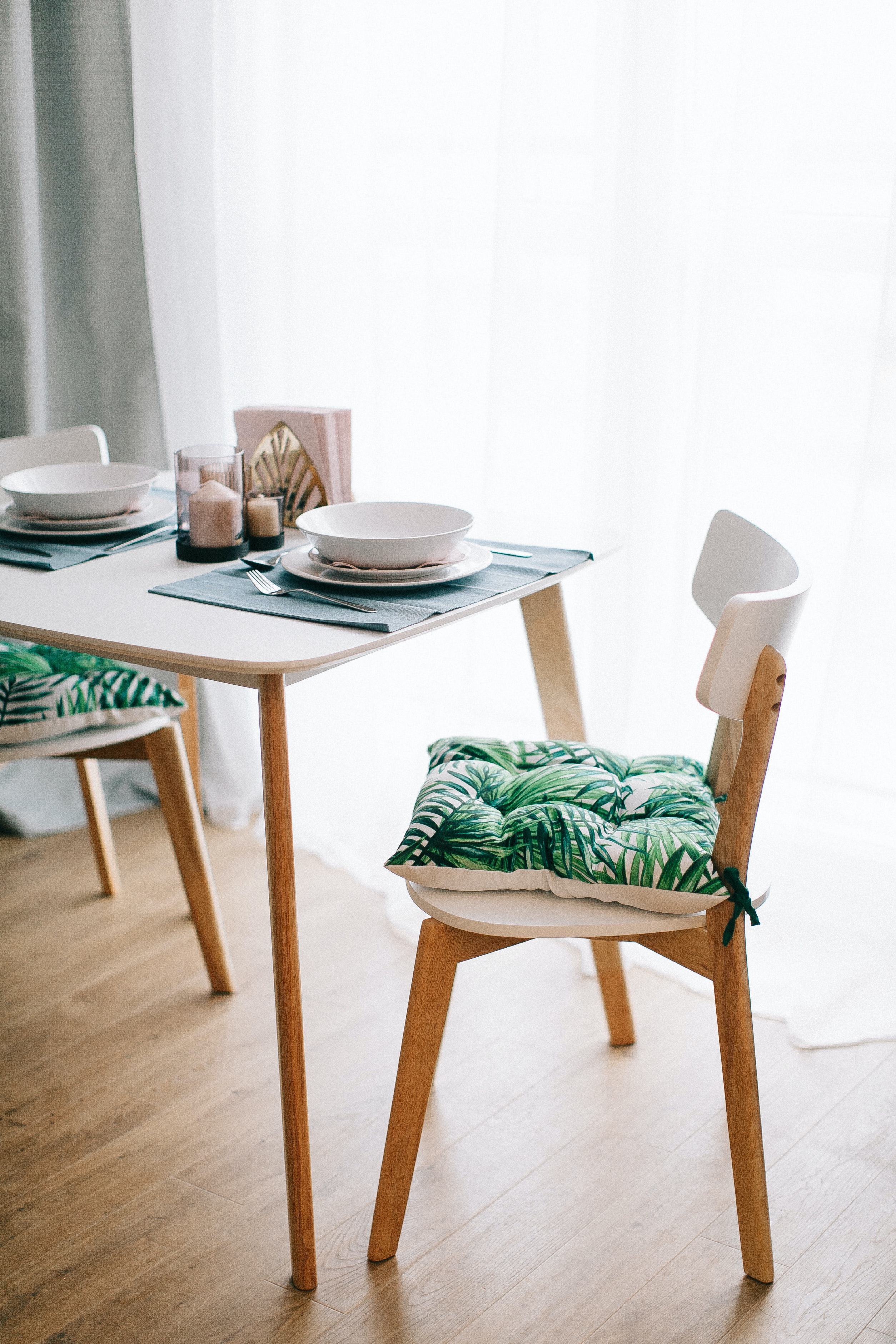 Chair with a cushion and plates on a dinner table