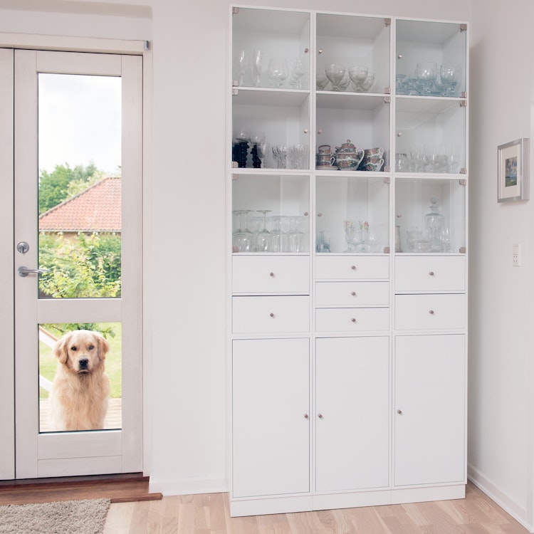 Full size cabinet in living room filled with glasses