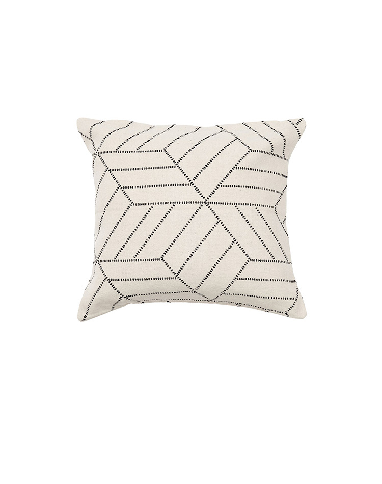 white pillow with black parallelograms design