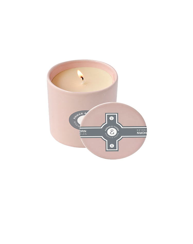 pink candle with dark green logo